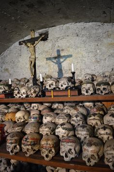 skulls and crucifixs on shelves in a church