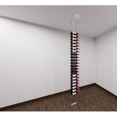 a wine rack in the corner of a room with wood floors and white walls, filled with bottles