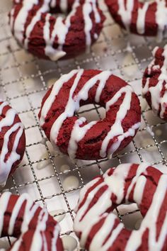 red velvet donuts with white icing on a cooling rack