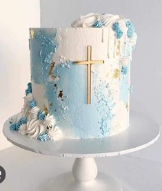 a blue and white cake with a cross on top