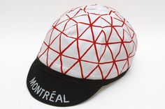 a white and black hat with red lines on it