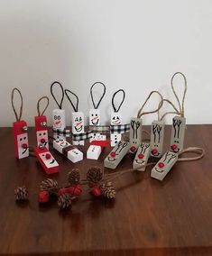 paper snowmen and pine cones are sitting on a table next to small bags with decorations