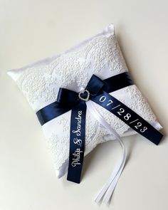 the ring bearer pillow is decorated with ribbon