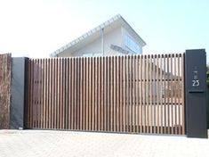 a large wooden fence next to a building with a number twenty on it's side