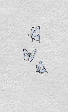 three butterflies are flying in the air