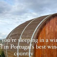 a wooden barrel with the words you're sleeping in a wine cellar in portugal's best winery country