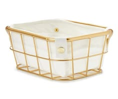 a white and gold basket with handles