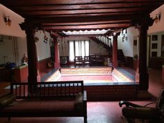 the inside of a house that is lit up with red lights and wooden furniture in it