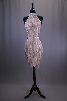 a dress on a mannequin with beads and sequins in the back