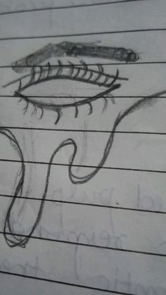 an eye drawn on lined paper with writing