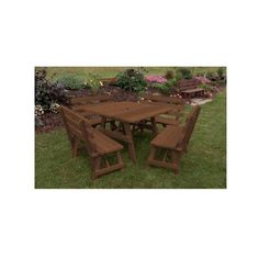 a wooden table and chairs sitting in the grass