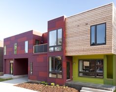 two story multi - family home with green and red exterior