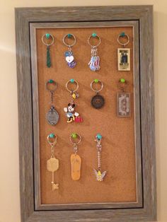 a shadow box with key chains and charms in it