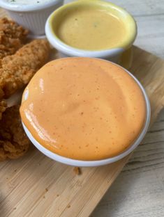 fried chicken and dipping sauce on a cutting board