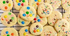 cookies with m & m candies and sprinkles on a cooling rack