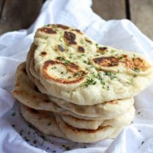 a stack of pita bread sitting on top of a white napkin