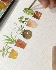 someone is painting with watercolors on paper