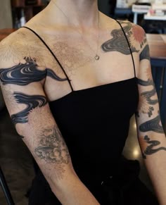 a woman with many tattoos on her arm