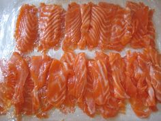 several pieces of raw salmon on plastic wrap