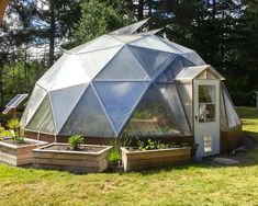 a small greenhouse in the middle of a field