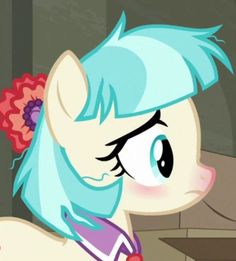 the pony has blue hair and is wearing a flower in her hair