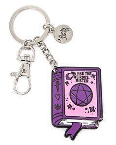 a purple book shaped keychain with the words we are the weirdest mister on it