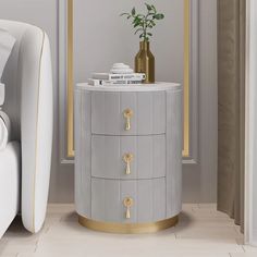 a white and gold side table next to a bed with a plant on top of it