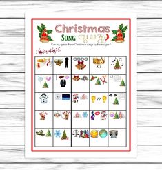 the christmas song quiz game is shown on a wooden table with white boards and red trimming