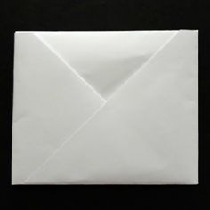 an origami envelope on a black background