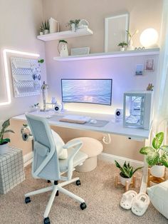 a white desk with a computer on it in a room filled with potted plants