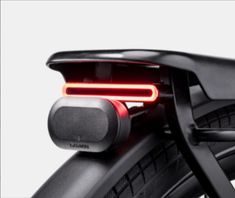 the rear end of a bicycle with its brake light on and it's tail light turned red