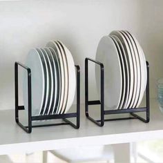 three plates are stacked on black metal holders