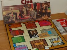 a clue board game sitting on top of a wooden table