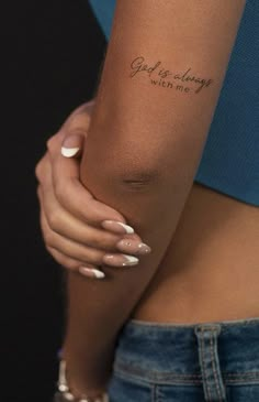 a woman's arm with a tattoo saying god is always within me on it