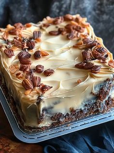 a cake with frosting and pecans on top