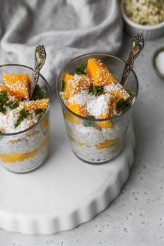 two small cups filled with food on top of a white plate