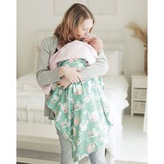 a woman holding a baby in her arms