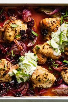 chicken with cranberry sauce and onions in a casserole dish, ready to be eaten