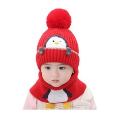 a small child wearing a red hat and scarf with a penguin on it's head