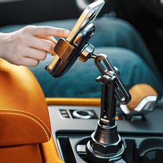 a person holding a cell phone while sitting in a car