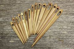 six wooden utensils sitting on top of a wooden table next to each other