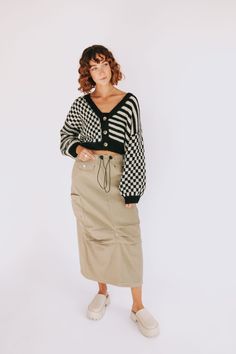 The Tough Luck Cargo Skirt is the perfect combination of fashion and utility. Its khaki colored denim fabric adds style to any look, while its functional cargo pockets let you keep your essentials close. From its drawstring waist and bottom to its midi/maxi length, this skirt is sure to add a little adventure to any day. Details Khaki colored denim skirt Cargo pockets Pockets on front hip are not functional Pockets on sides and in back are functional Functional drawstring at waist & bottom Midi/ Cargo Maxi Skirt Outfit, Khaki Skirt Outfit, Khaki Skirt Outfits, Cargo Skirt Outfit, Skirt Cargo, Utility Skirt, Midi Skirt Outfit, Zara Collection, Khaki Skirt