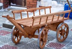 a wooden wagon sitting on top of a sidewalk