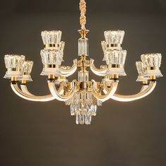 a gold chandelier with many crystal pieces hanging from it's centerpiece