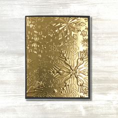 a gold card with snowflakes on it