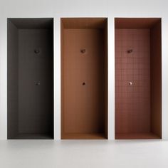 three different colored stalls in an empty room