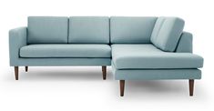 a blue sectional sofa with wooden legs and foot rest on an isolated white background,