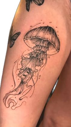 a black and white photo of a jellyfish with butterflies on it's arm