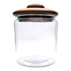 a glass jar with a wooden lid on a white background