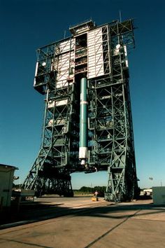 a large metal structure sitting on top of a tarmac next to a sky background